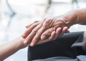 Palliative care home CHSLD L.B.-Desjardins, Senior persons hand holding younger persons hand